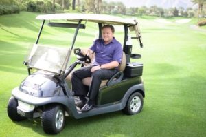 Man on the rise- Paul Levy on golf cart